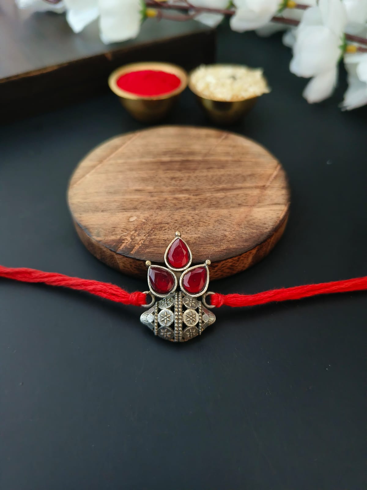 Floral Dome Rakhi with Red Stones & Silver Polish | AMOLA