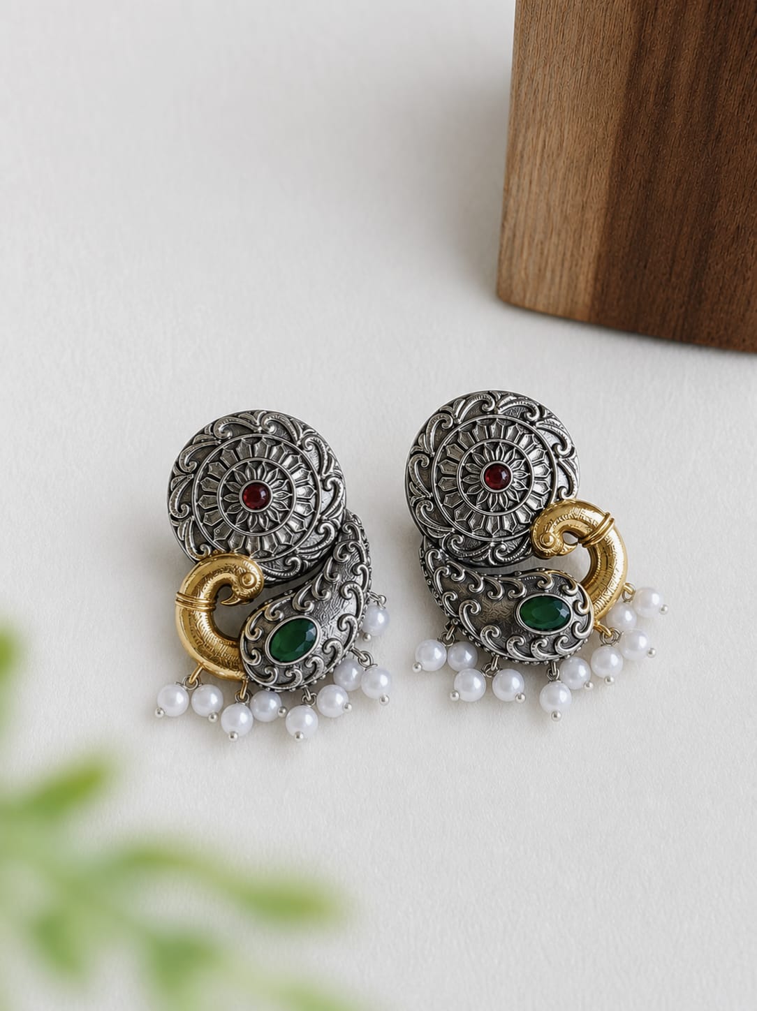 Dual-tone peacock-motif stud earrings